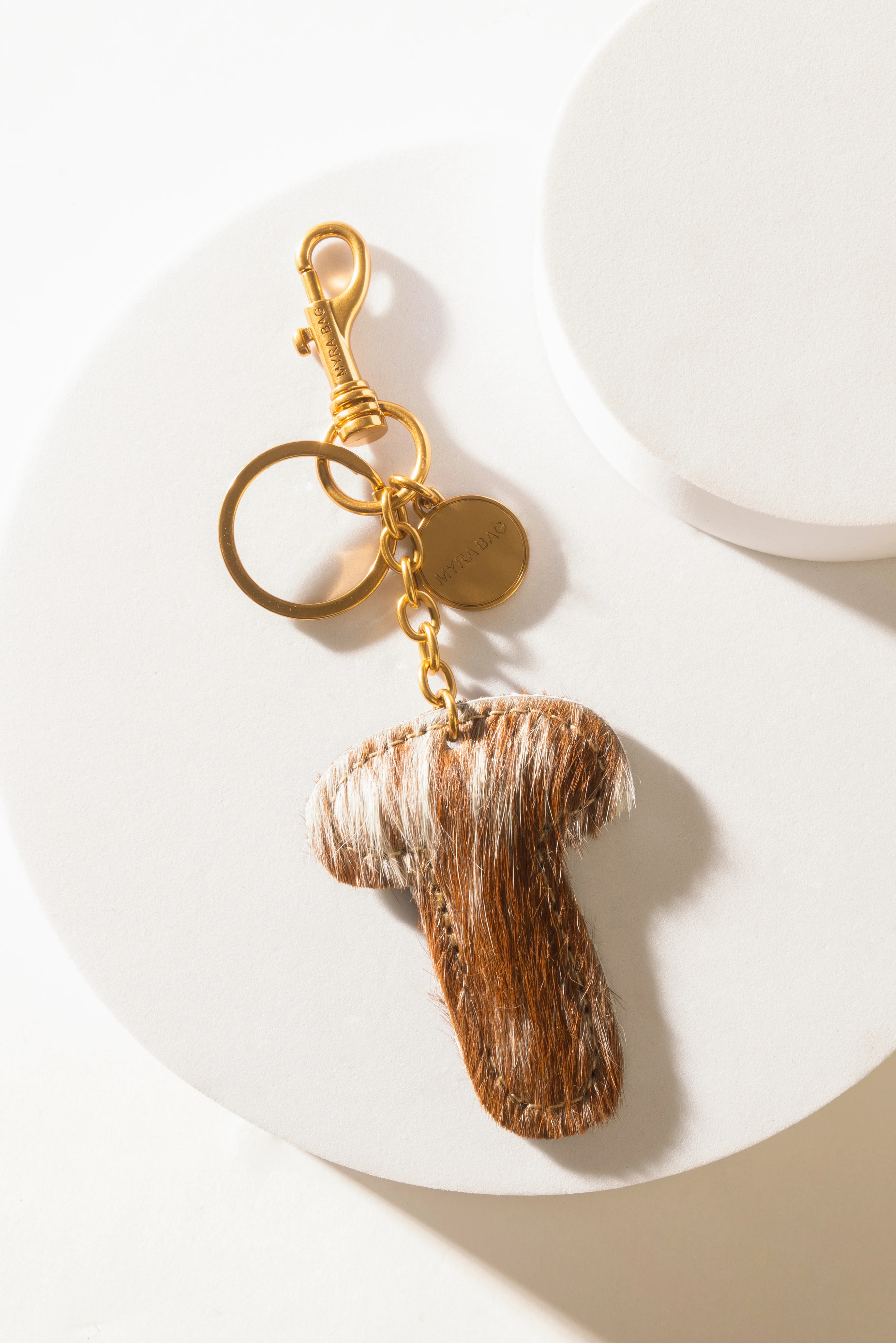 364-alpha-hairon-bag-charm-in-brown-white-1.webp