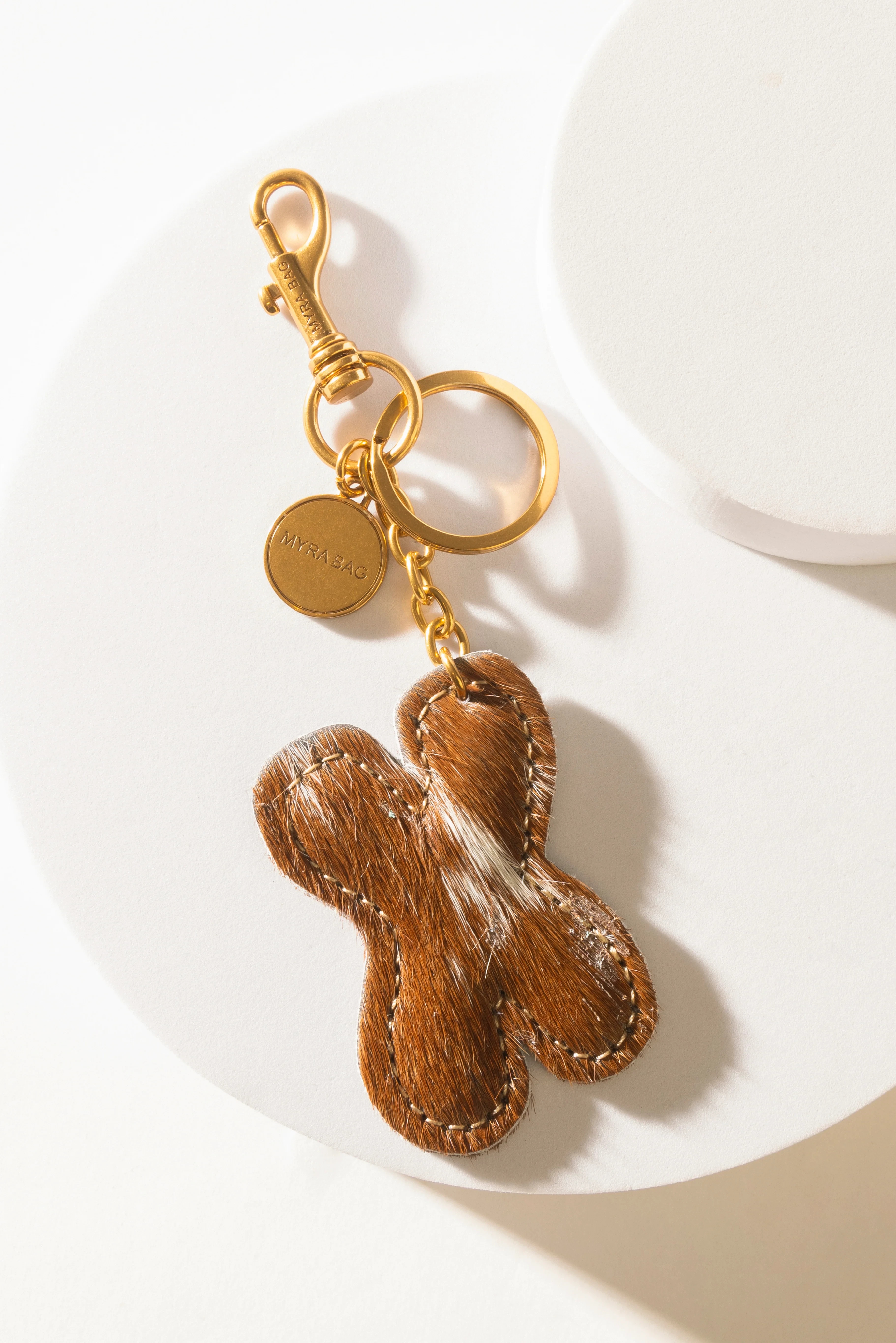 364-alpha-hairon-bag-charm-in-brown-white-1.webp
