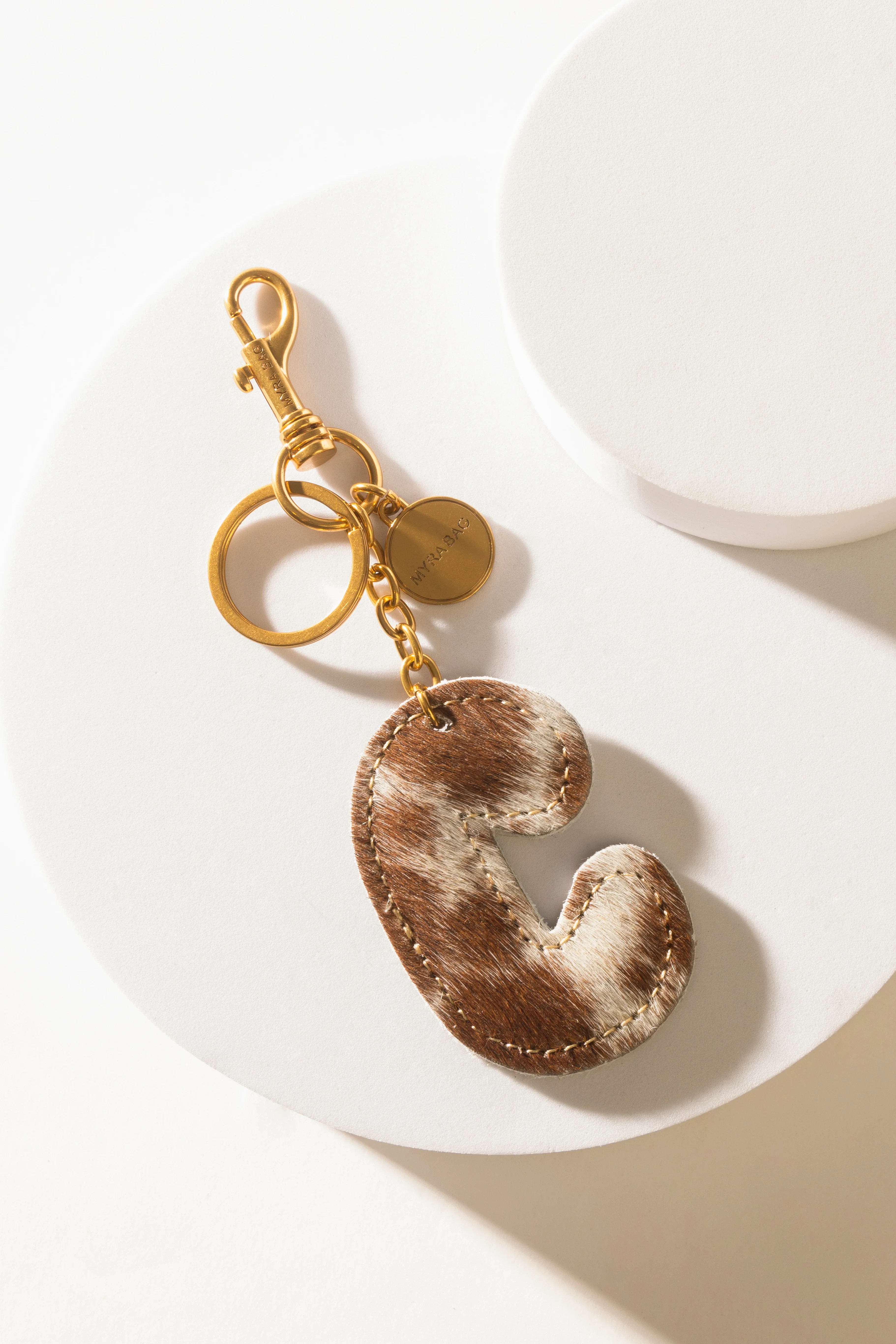 364-alpha-hairon-bag-charm-in-brown-white-1.webp