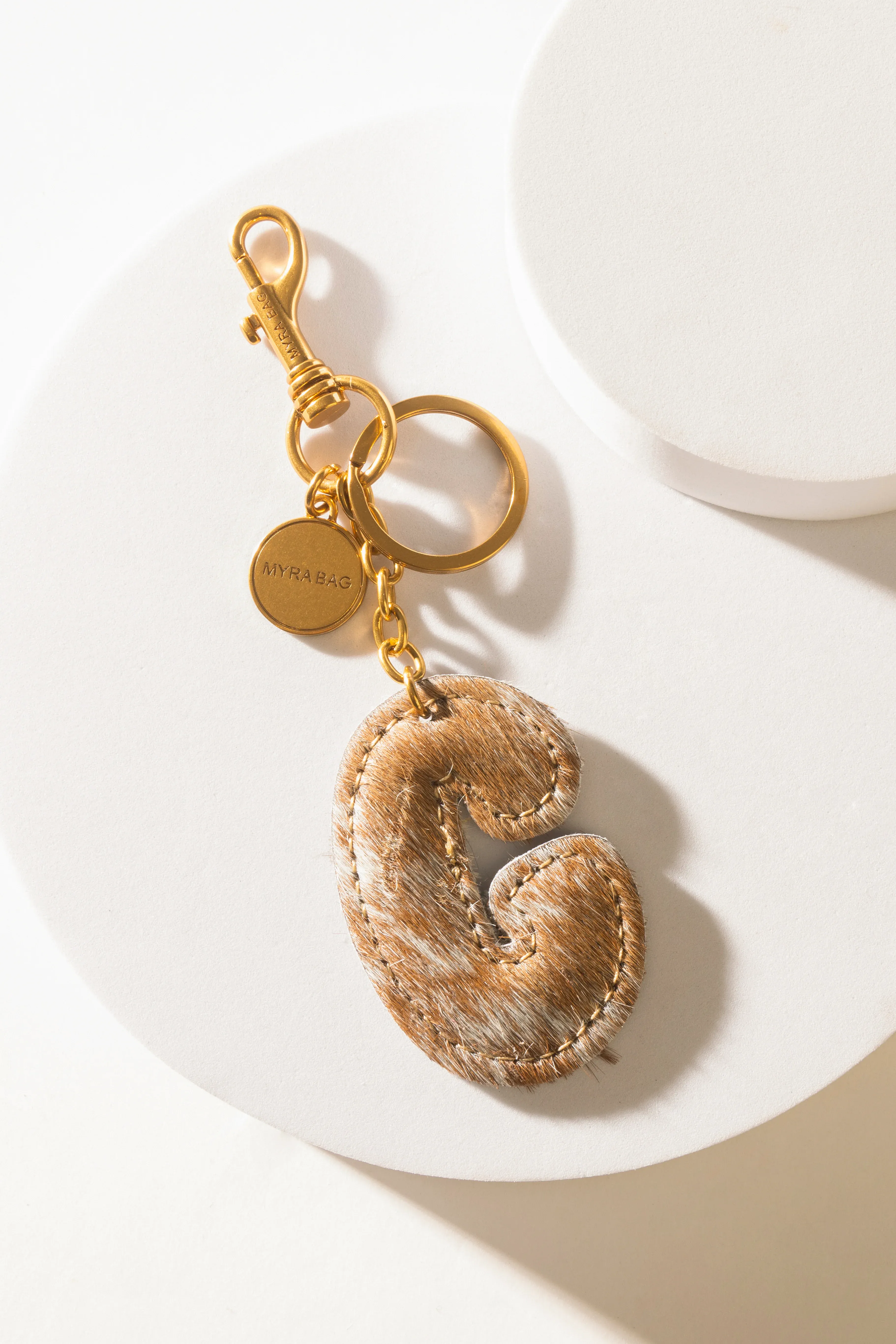 364-alpha-hairon-bag-charm-in-brown-white-1.webp